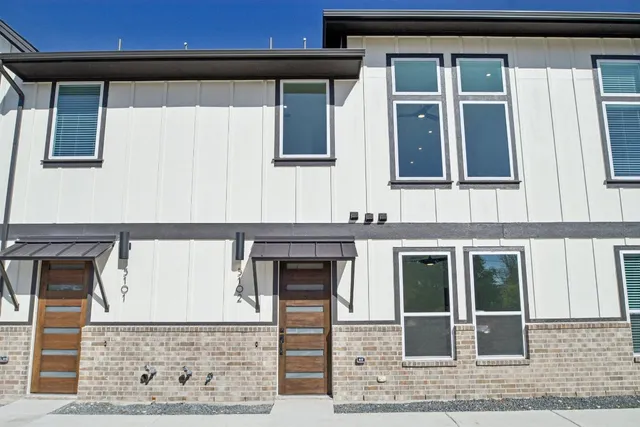 a front view of a house with large windows