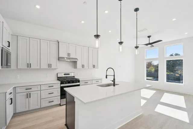 a kitchen with appliances cabinets and a sink