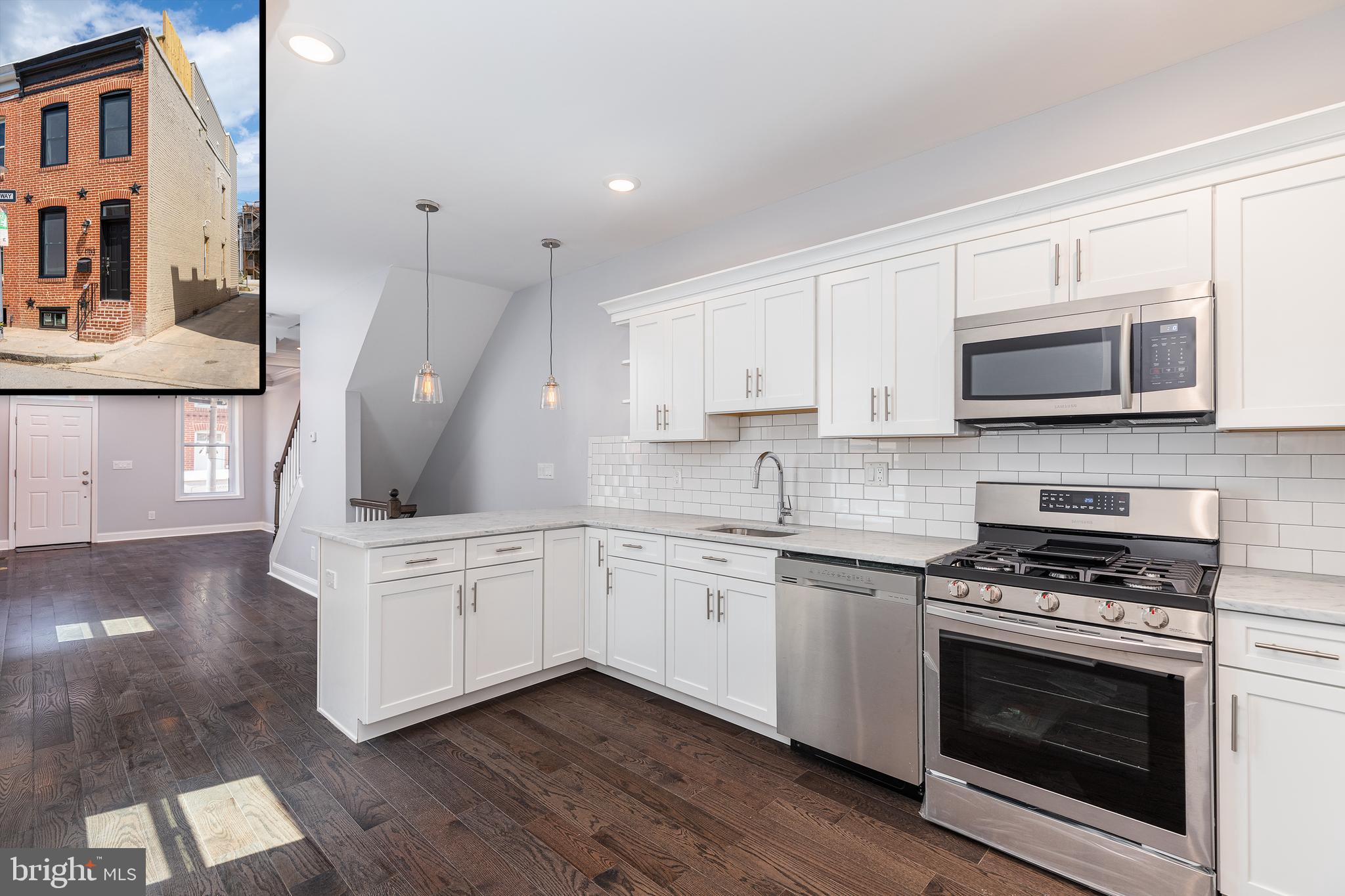 a kitchen with stainless steel appliances granite countertop a stove a sink and a microwave