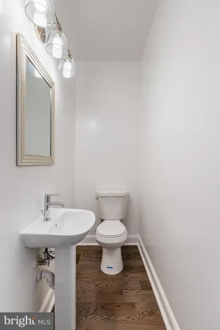 a bathroom with a sink a toilet and mirror