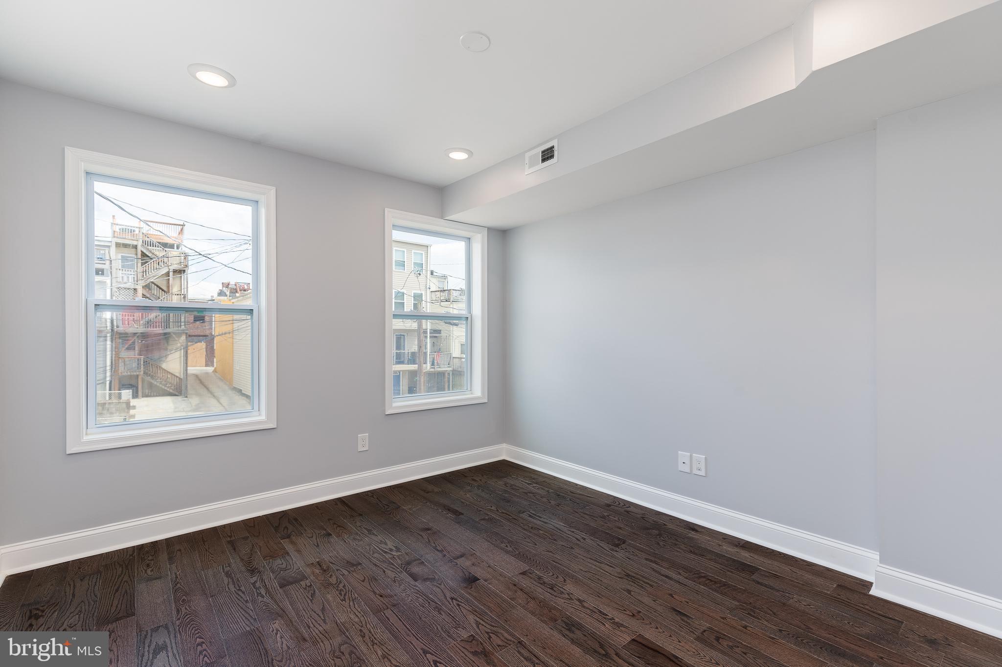 1701 Patapsco Street Baltimore, MD 21230 - Photo 22 of 52 an empty room with wooden floor and windows