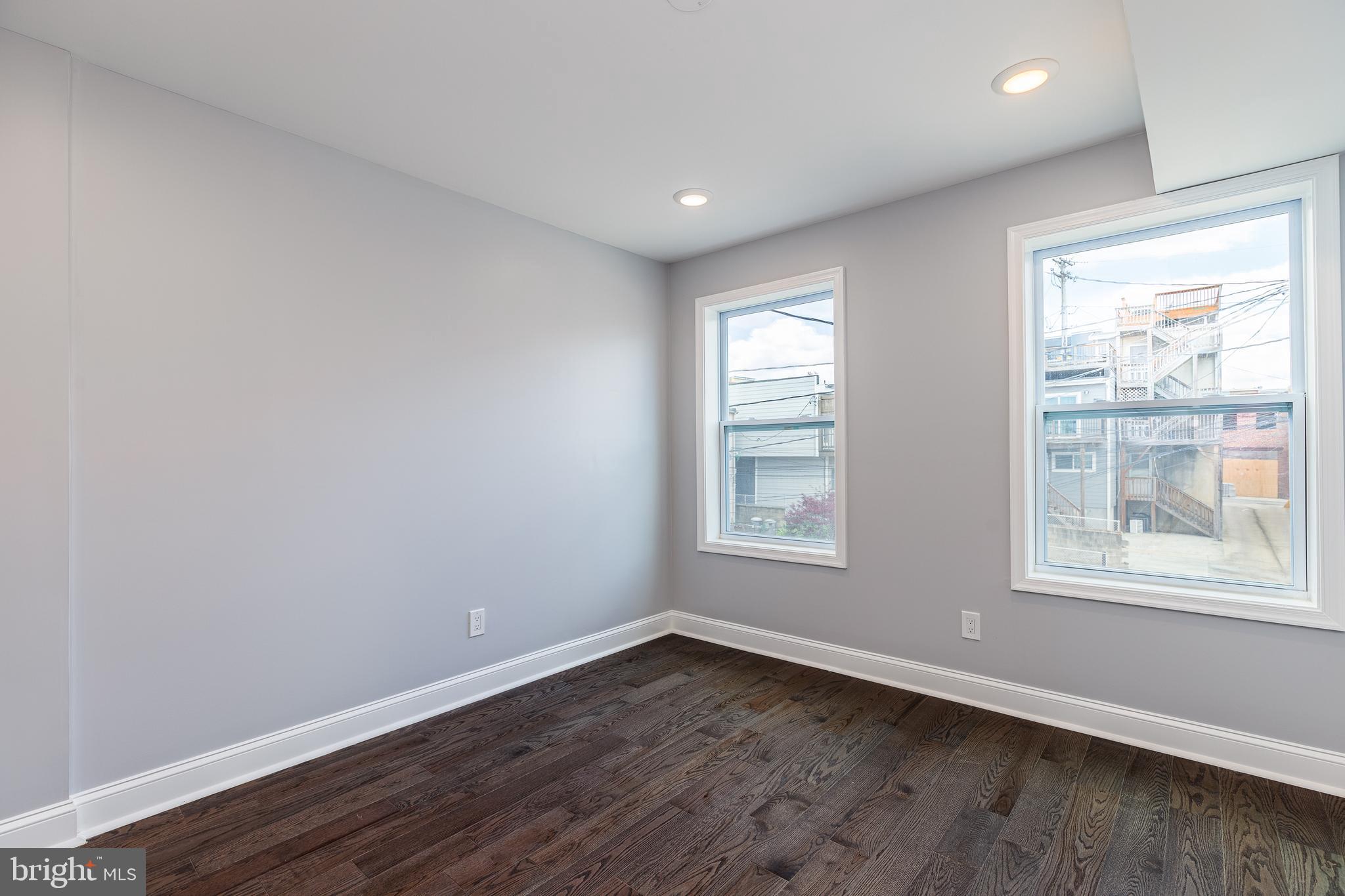 1701 Patapsco Street Baltimore, MD 21230 - Photo 25 of 52 an empty room with wooden floor and windows