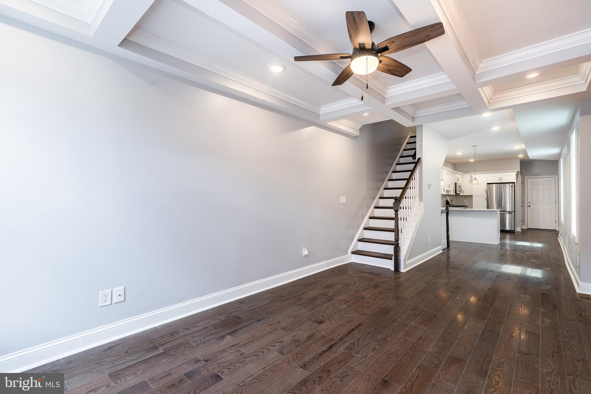 1701 Patapsco Street Baltimore, MD 21230 - Photo 3 of 52 a view of an empty room with stairs and a ceiling fan