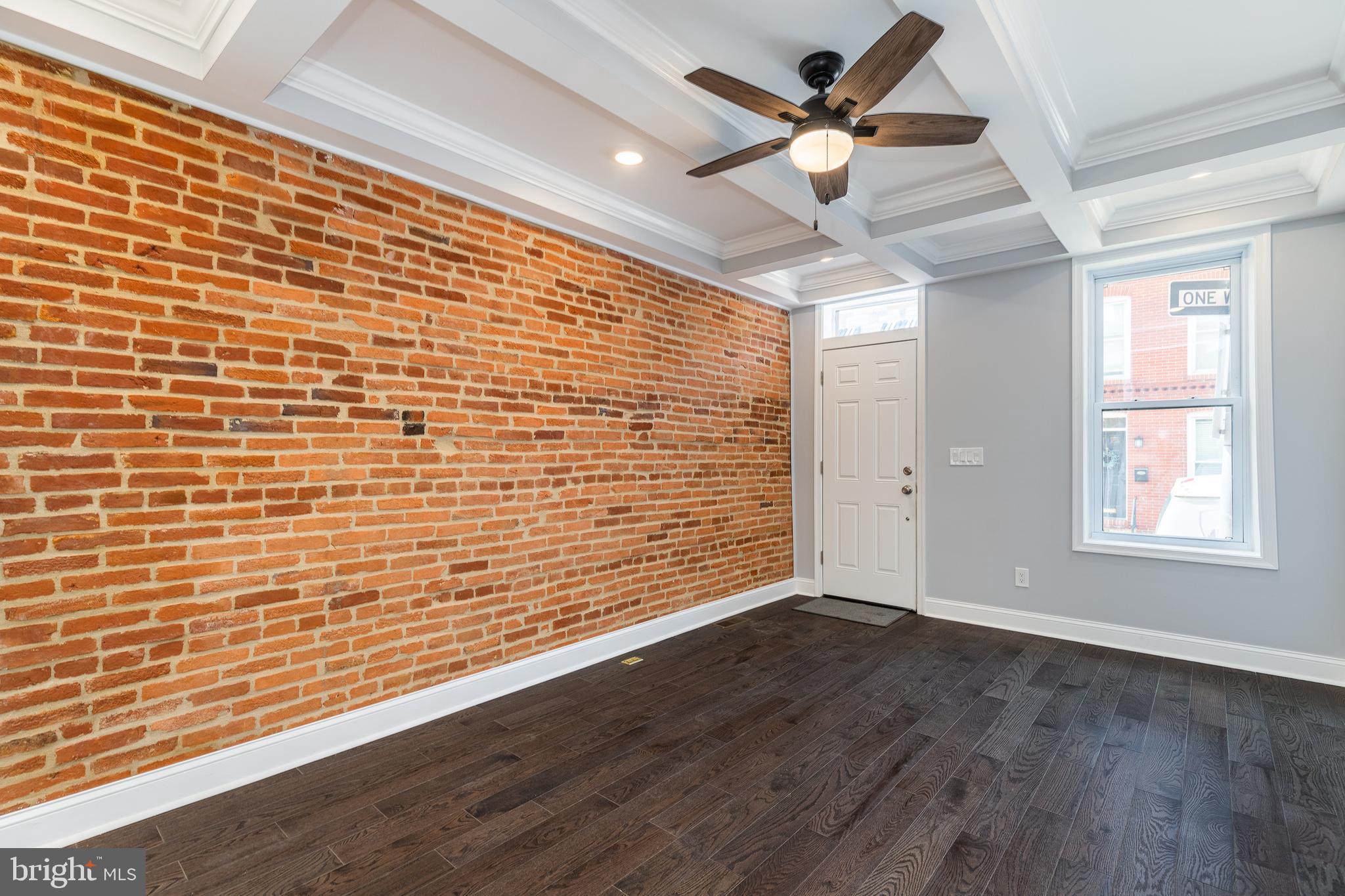 1701 Patapsco Street Baltimore, MD 21230 - Photo 5 of 52 a view of an empty room with a window and a ceiling fan