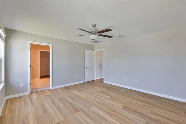 a view of an empty room with wooden floor