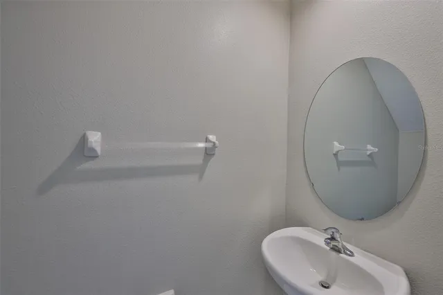 a bathroom with a sink and mirror
