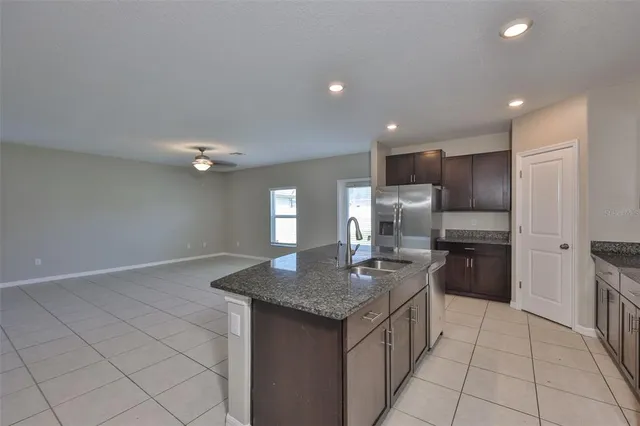 a kitchen with stainless steel appliances granite countertop a sink and a stove