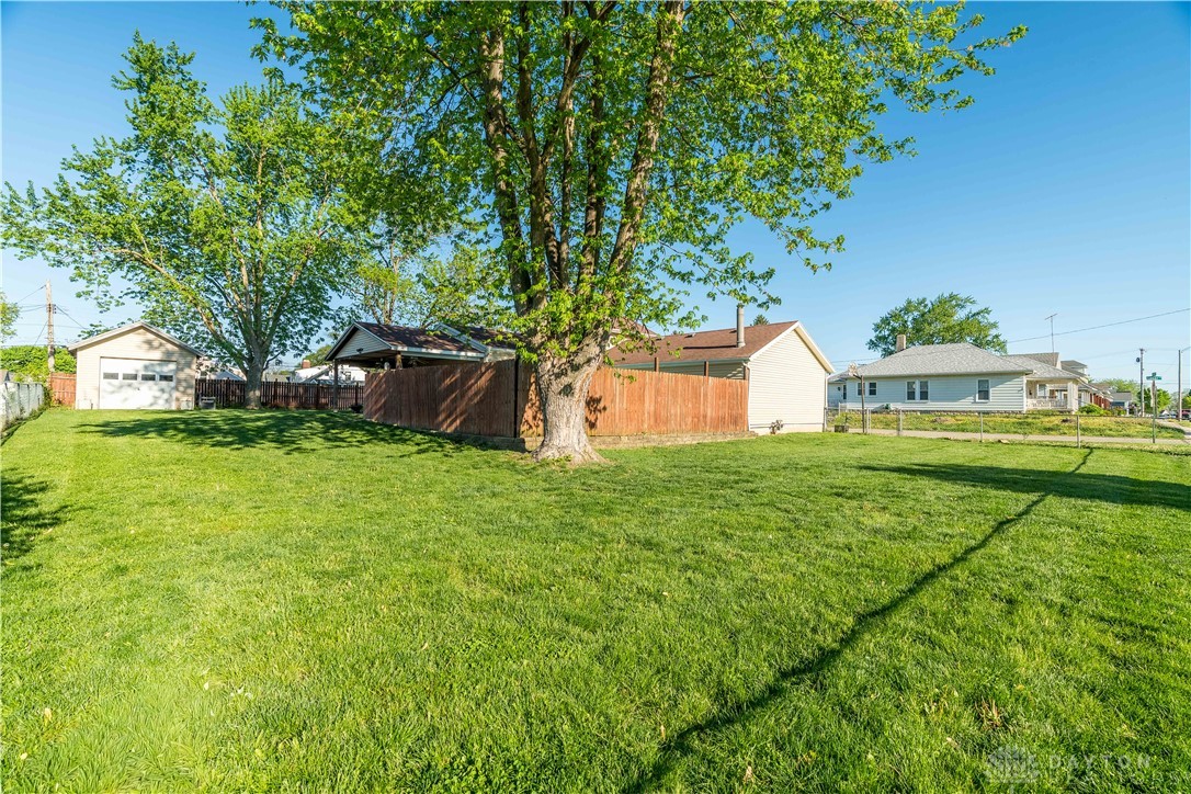 220 Racer Street Troy, OH 45373 - Photo 26 of 33 Expansive green lawn offers ample space for outdoor enjoyment and play.