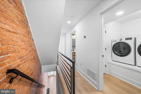 a view of entryway with furniture and wooden floor