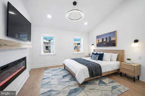a bedroom with a bed and a flat screen tv