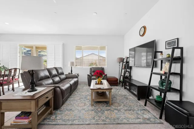 a living room with furniture kitchen and a table