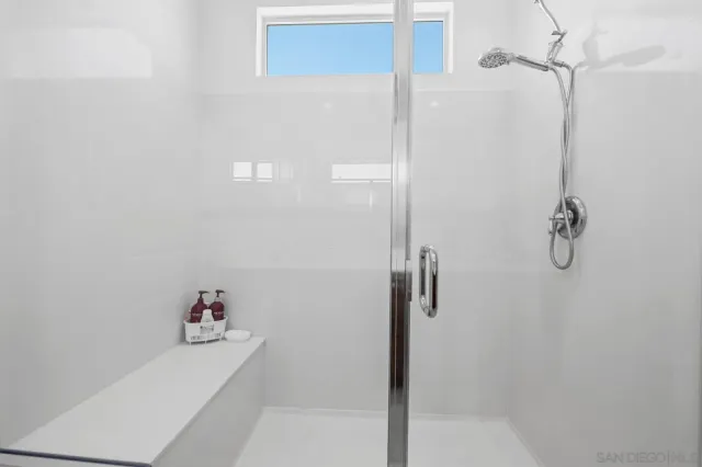 a view of walk in closet with clothes