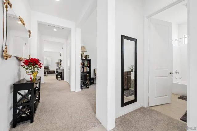 a bedroom with a bed table chair and a window