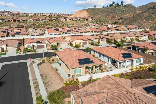 an aerial view of residential house and sandy dunes