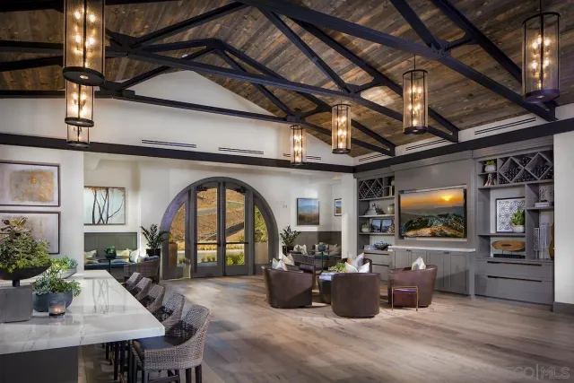 a living room with furniture and kitchen view