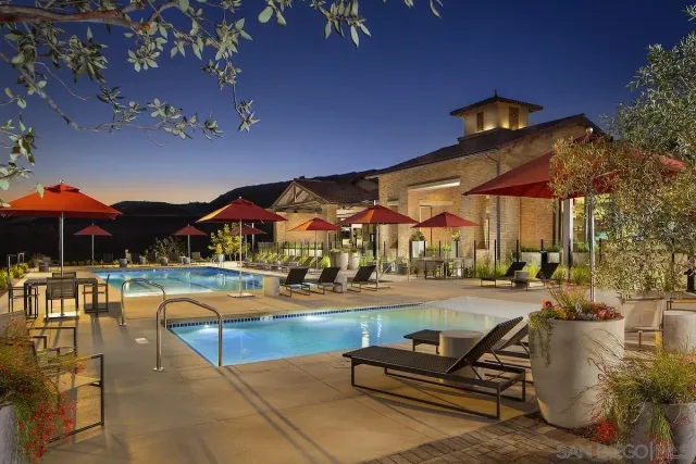 a living room with patio furniture and a floor to ceiling window