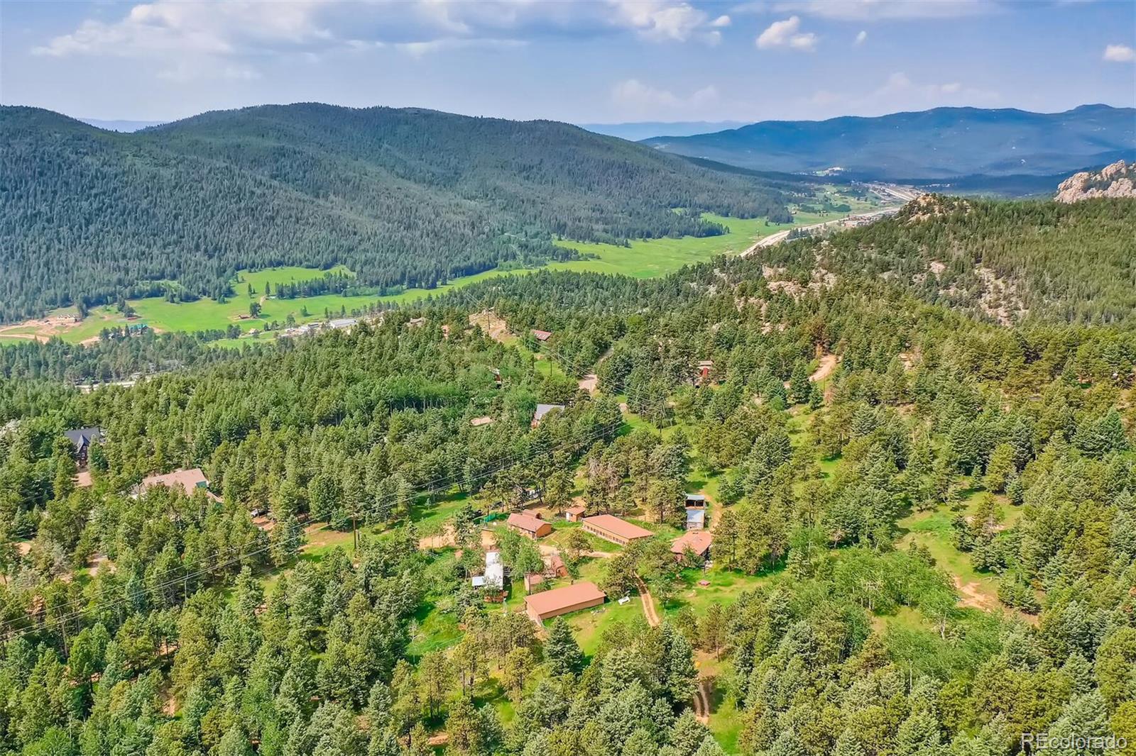 8939 South Hillview Road Morrison, CO 80465 - Photo 9 of 39 a view of a lush green hillside and houses