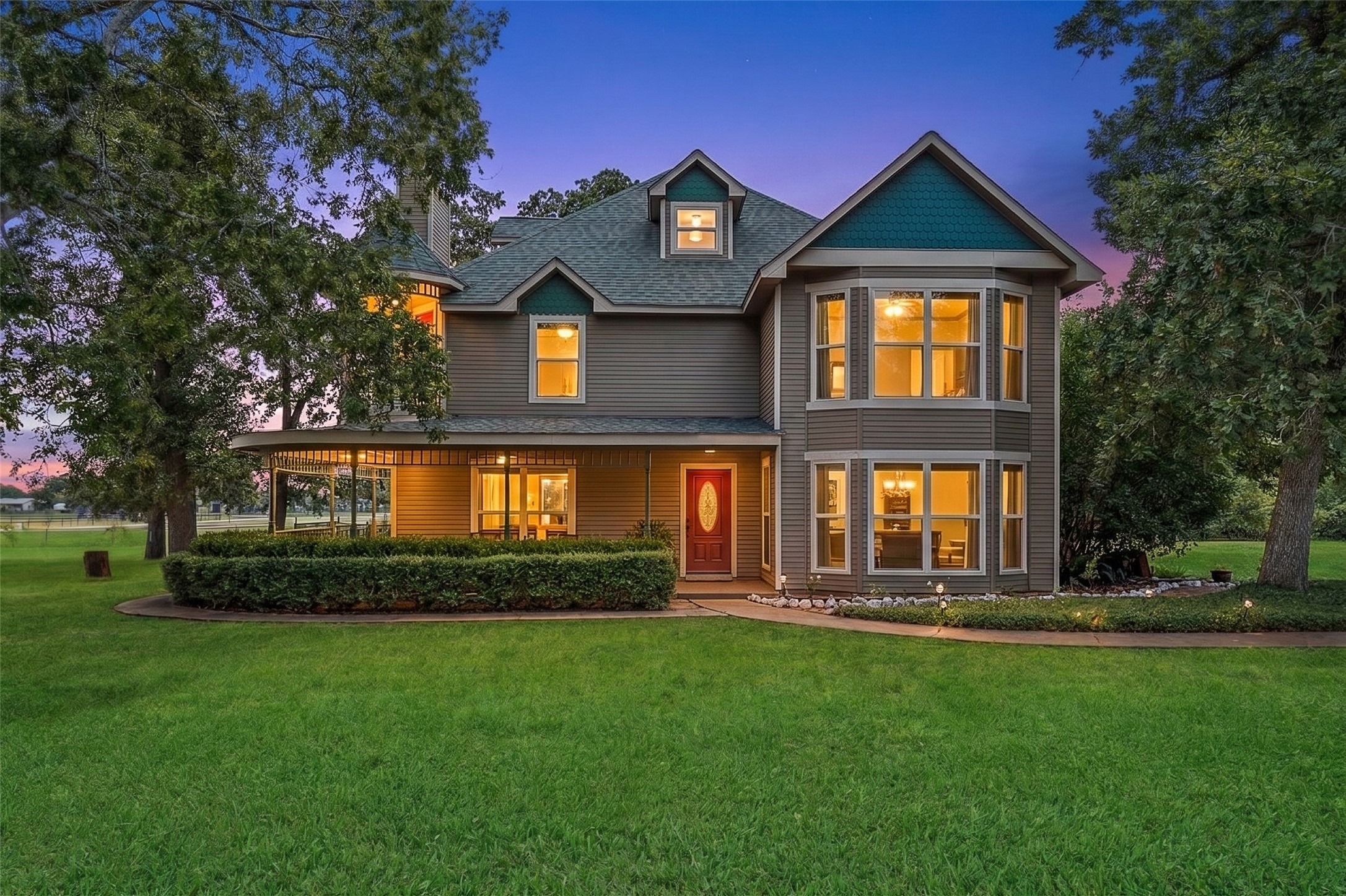 25948 Nelson Road Hempstead, TX 77445 - Photo 2 of 46 Impressive front exterior showcasing the stately three-story Victorian-style residence, mature trees, expansive lawn, and welcoming covered entry.