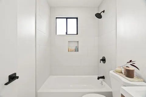 a bathroom with a bathtub and shower