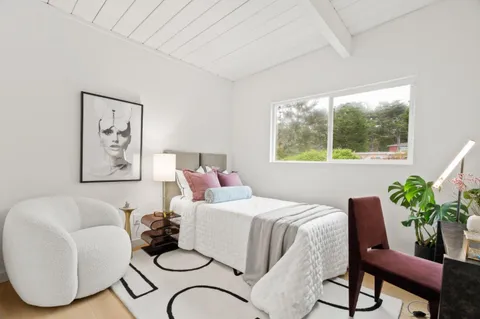 a bedroom with a bed and a couch