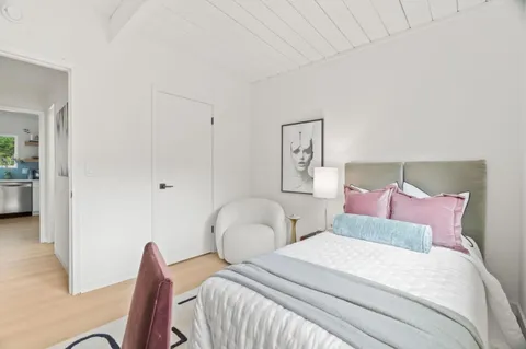 a bedroom with a bed and a couch