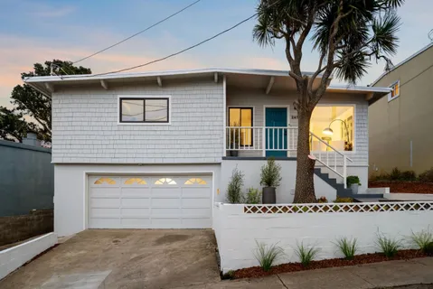 a front view of a house with a garage