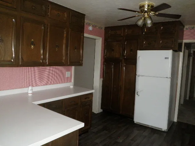 a kitchen with a refrigerator and a stove