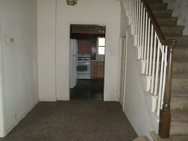 a view of a hallway with a kitchen space