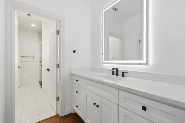 a view of an empty room with window and a kitchen
