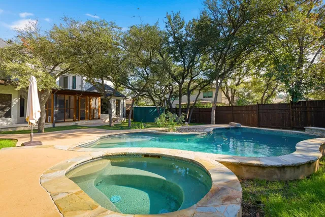 a front view of a house with swimming pool having outdoor seating