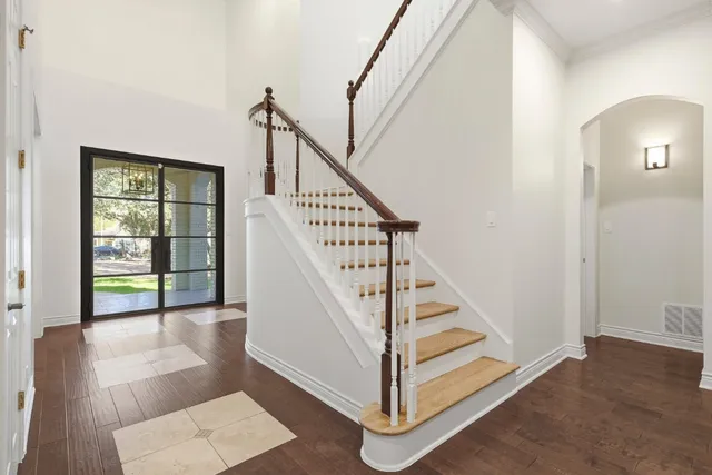 a view of entryway and hall with wooden floor