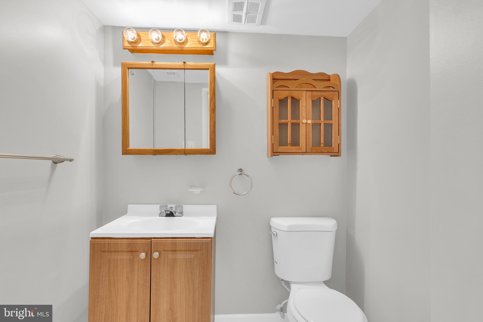 11620 Vantage Hill Road, Unit 22B Reston, VA 20190 - Photo 18 of 24 a bathroom with a toilet a sink and mirror