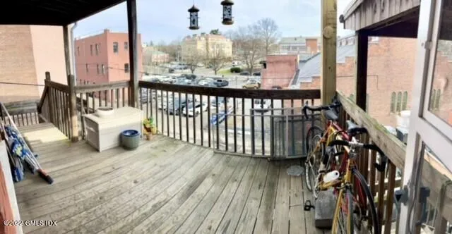 a view of a balcony with wooden floor