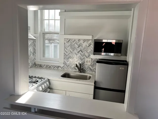 a kitchen with a sink and a refrigerator