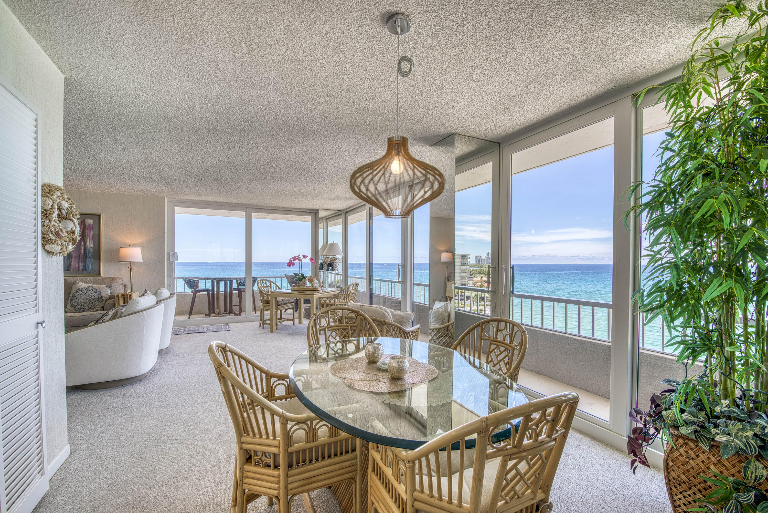 5540 North Ocean Drive, Unit 7A Singer Island, FL 33404 - Photo 15 of 26 a dining room with furniture a chandelier and window