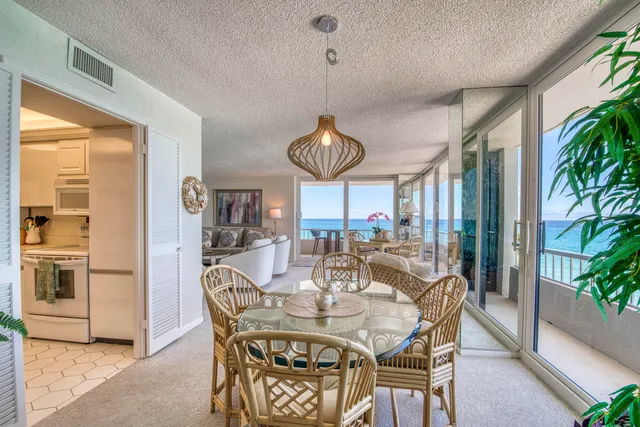 a dining room with furniture a chandelier and wooden floor