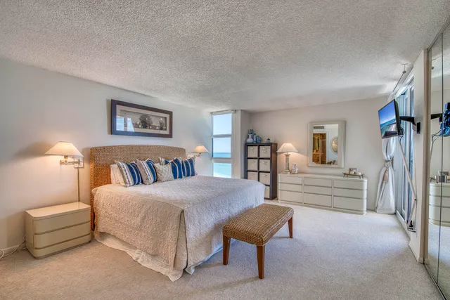 a bedroom with furniture and a lamp