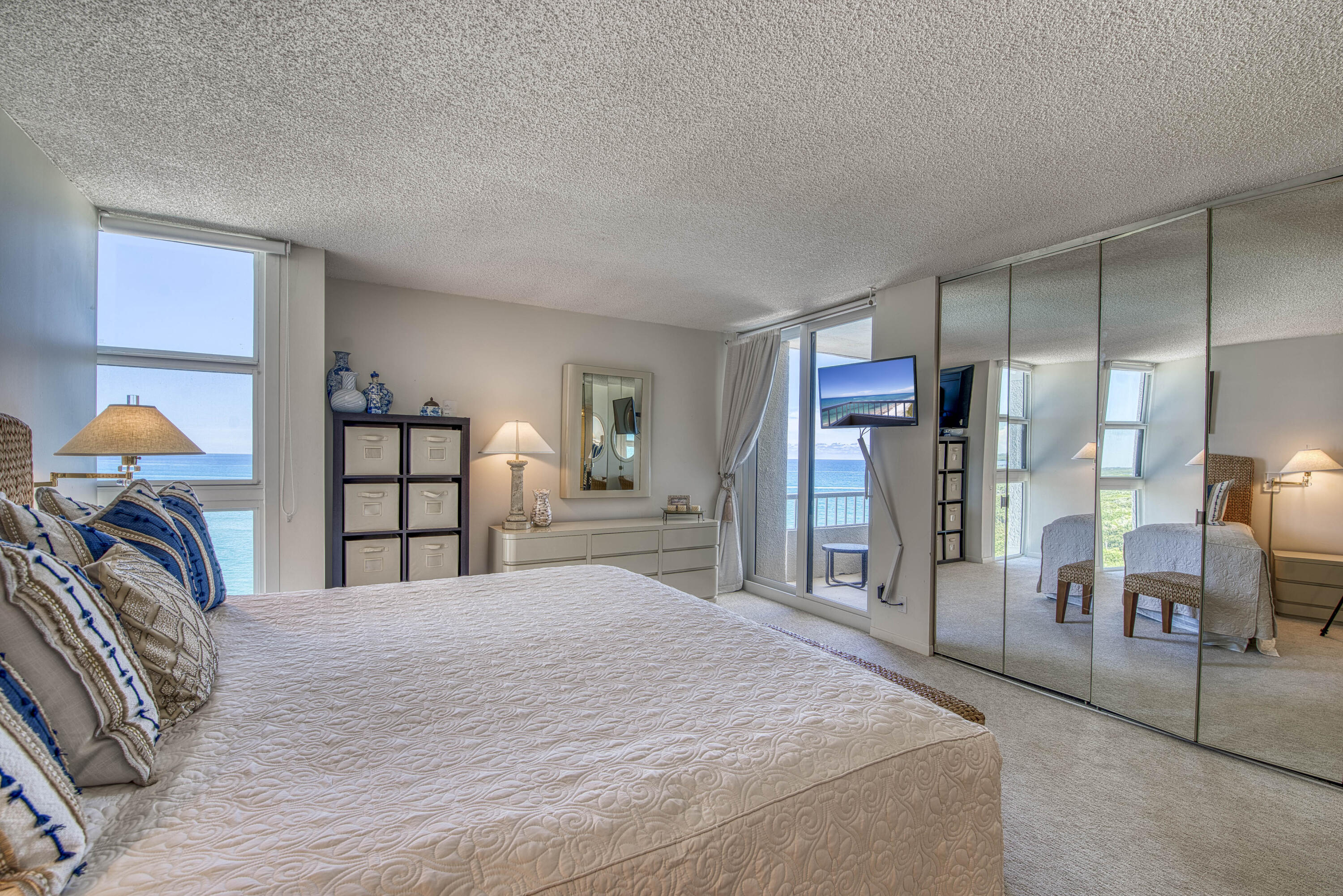 5540 North Ocean Drive, Unit 7A Singer Island, FL 33404 - Photo 22 of 26 a bedroom with a bed and a view of closet