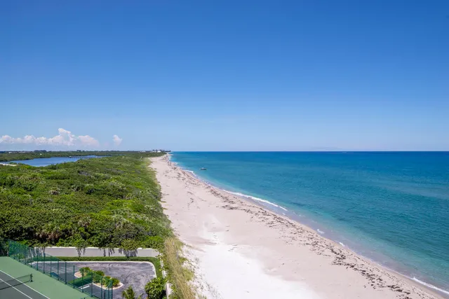 a view of an ocean beach and mountain