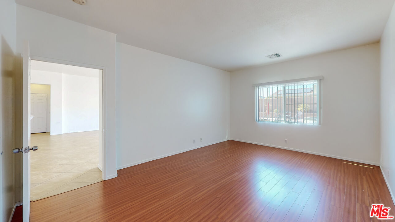 68606 La Medera Road Cathedral City, CA 92234 - Photo 12 of 33 an empty room with wooden floor and windows