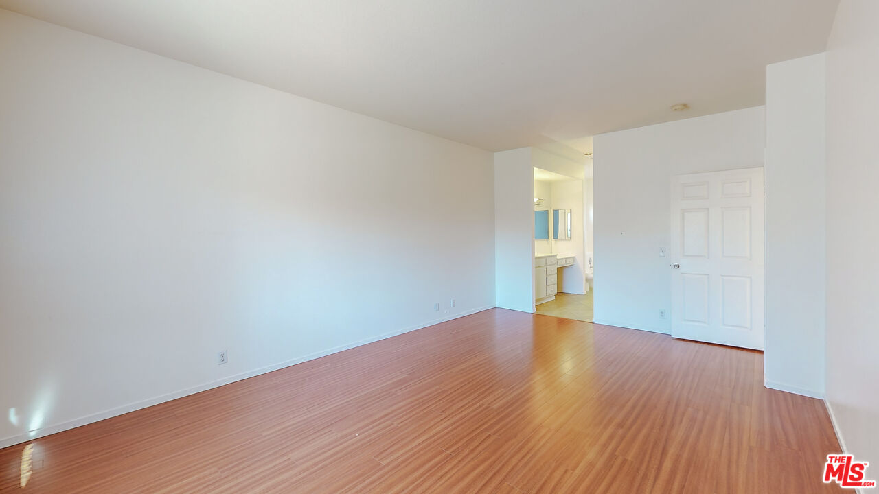 68606 La Medera Road Cathedral City, CA 92234 - Photo 13 of 33 a view of an empty room with wooden floor and a window