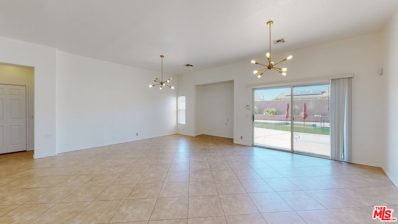 68606 La Medera Road Cathedral City, CA 92234 - Photo 5 of 33 a view of an empty room with a chandelier
