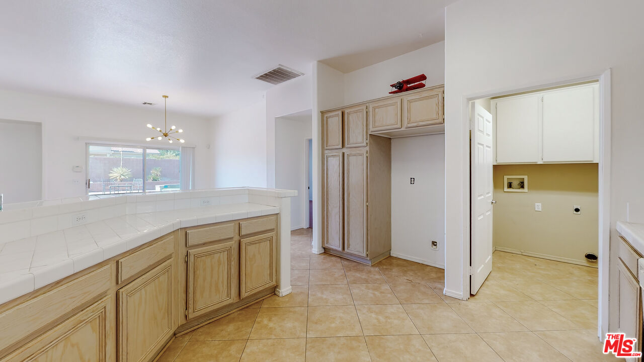68606 La Medera Road Cathedral City, CA 92234 - Photo 9 of 33 a bathroom with a granite countertop sink mirror and cabinets