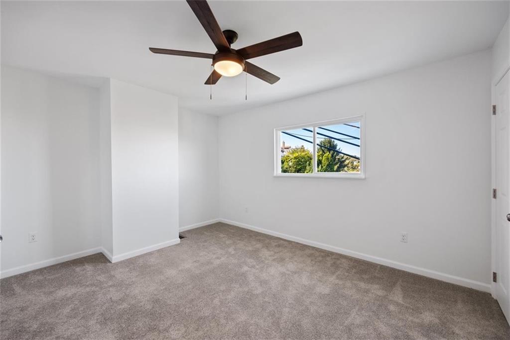 39 Eleanor Street Pittsburgh, PA 15203 - Photo 16 of 25 an empty room with a ceiling fan and window