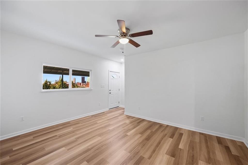 39 Eleanor Street Pittsburgh, PA 15203 - Photo 6 of 25 an empty room with a window and ceiling fan