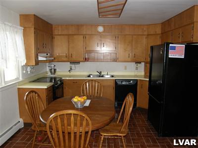 526 Fulmer Road Nazareth, PA 18064 - Photo 11 of 15 a kitchen with stainless steel appliances granite countertop a table chairs in it and a window