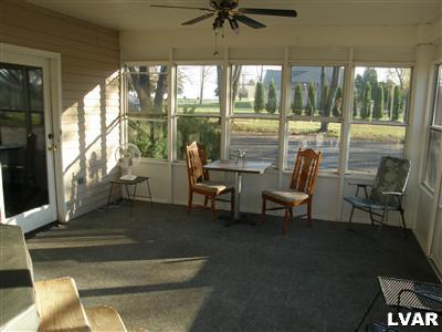 526 Fulmer Road Nazareth, PA 18064 - Photo 7 of 15 a living room with couches and a dining table with garden view