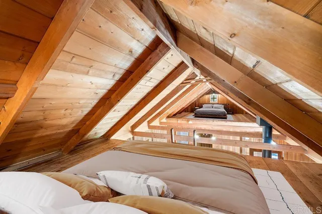 a bed sitting in a bedroom next to a window