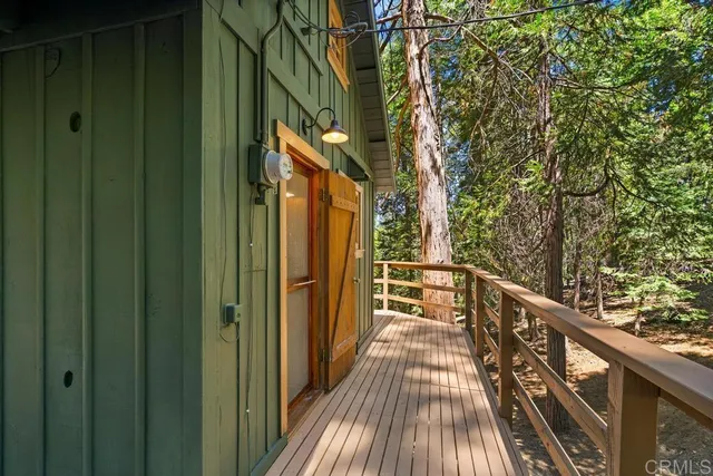 a view of balcony with wooden floor and fence