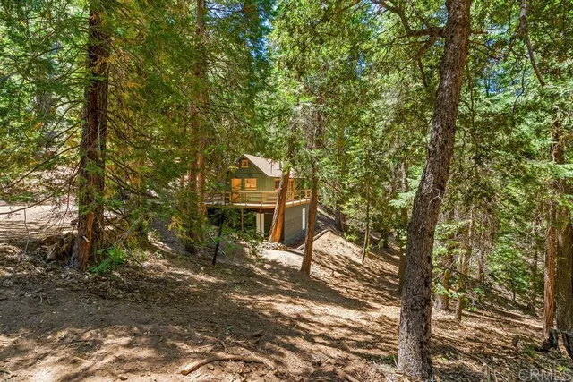 a view of a house with a tree in front of it